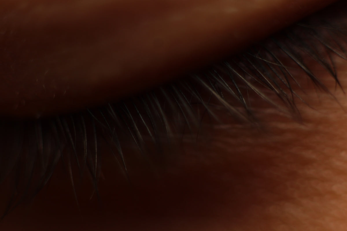 Close-up of dark eyelashes against skin